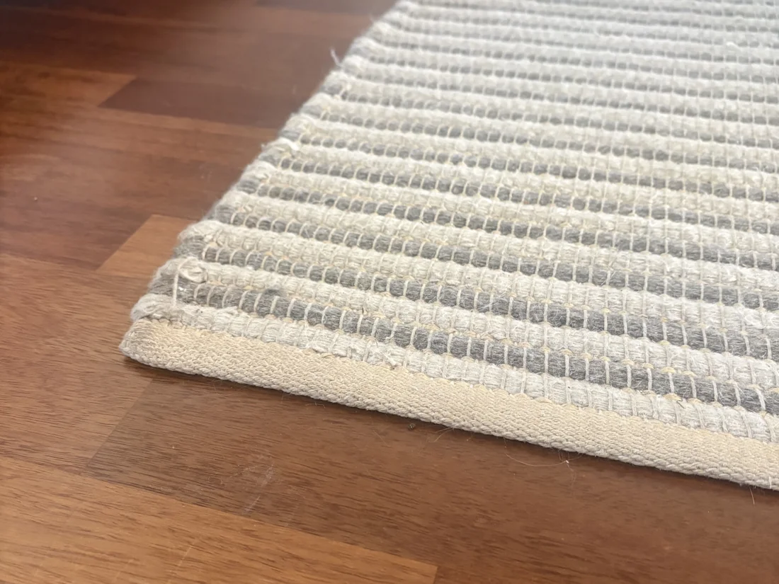 Servido professional hand-washing a rug with a brush